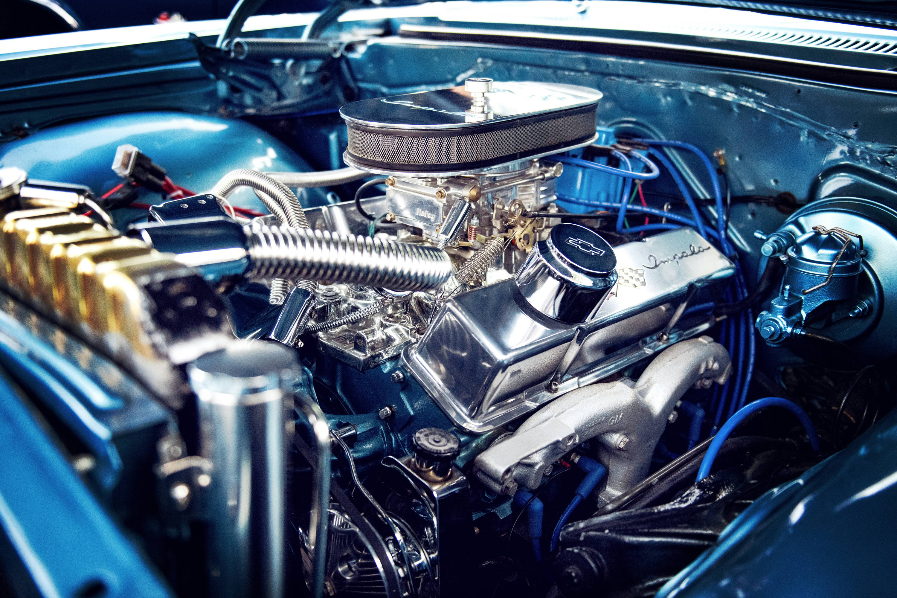 Chevrolet Impala V8 engine bay, polished chrome engine components and blue spark plug wires
