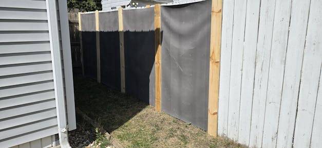 reinforced mass loaded vinyl on a wood fence