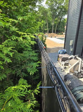 residential equipment with sound blankets on chain link fence