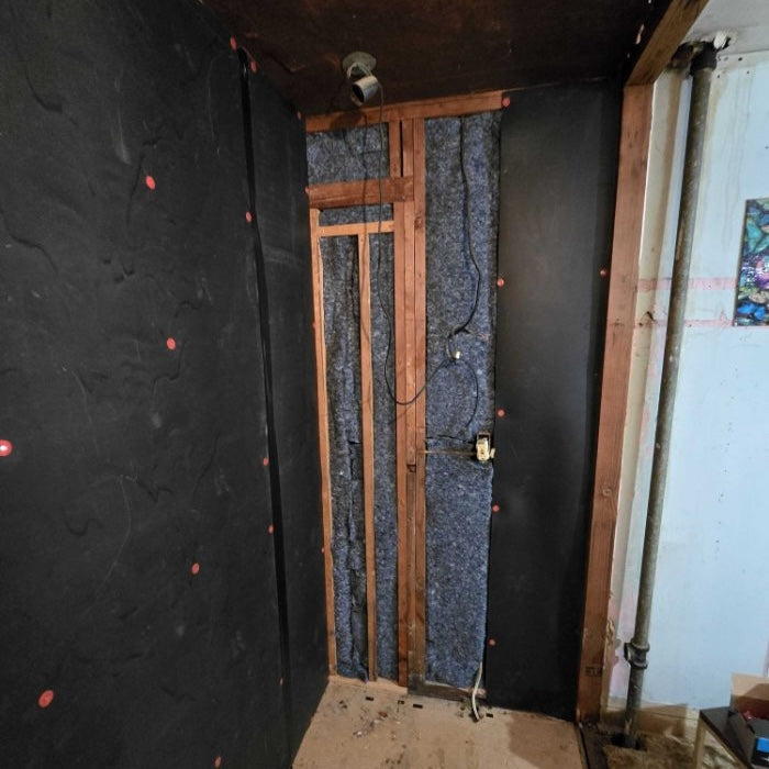 mass loaded vinyl rolls used in combination with ultratouch denim insulation on a residential wall
