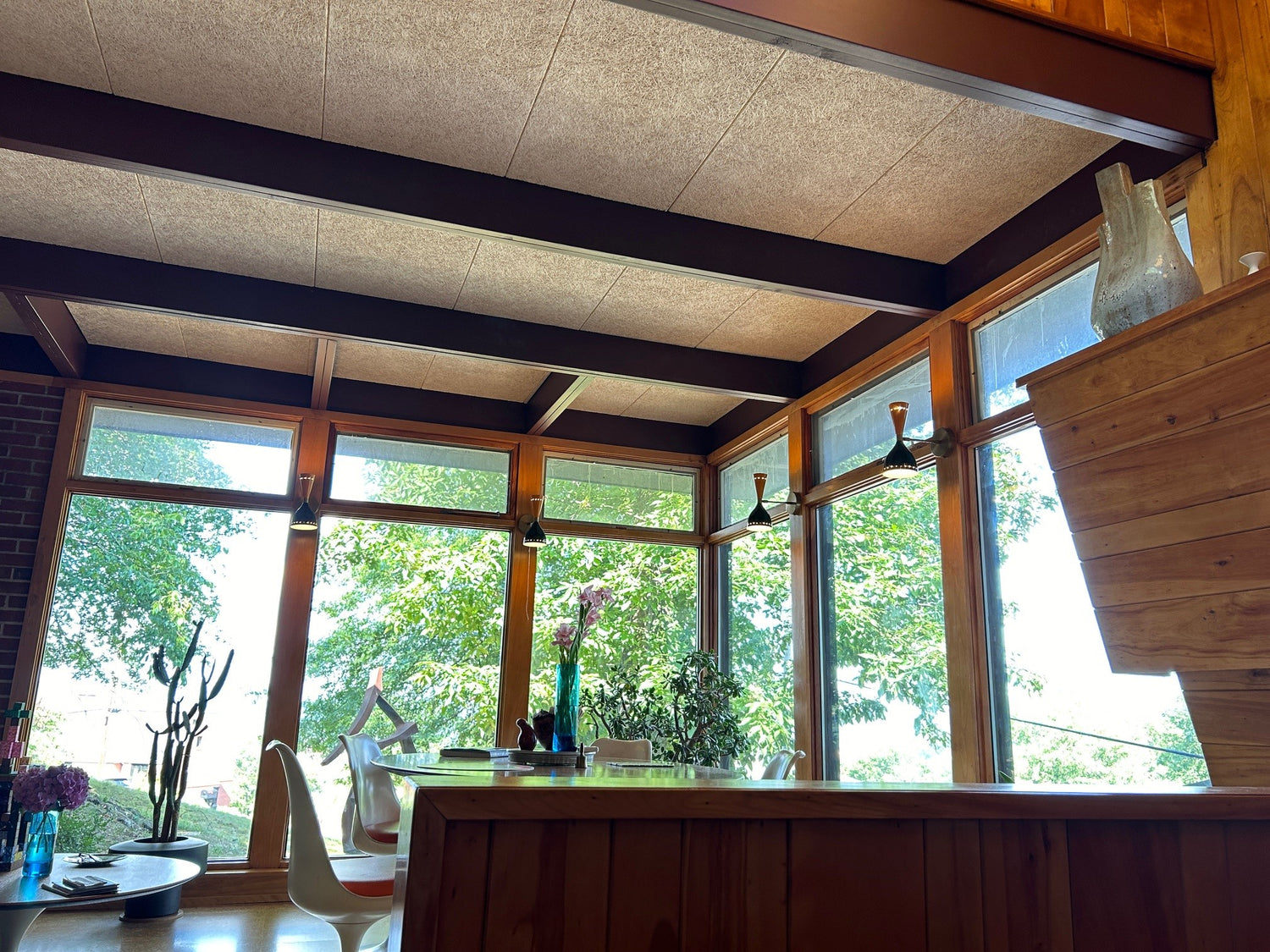 Timberwool Ceiling Tiles installed in mid-century modern dining room with exposed wood beams and panoramic windows