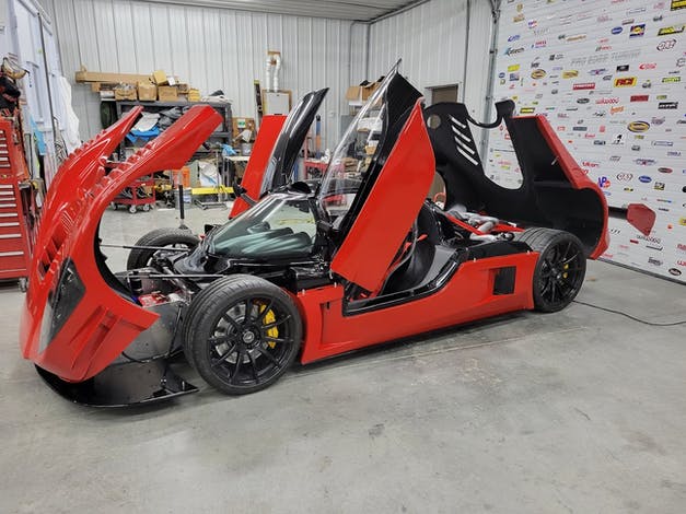 Spectrum Sludge liquid deadener applied to red supercar chassis in performance shop