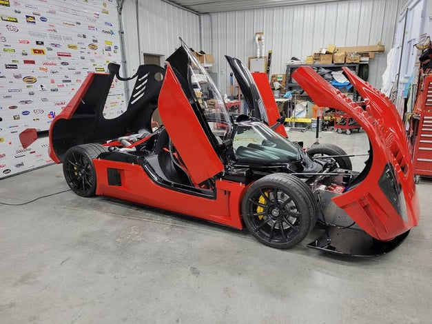 Spectrum Sludge liquid sound deadener applied to red exotic supercar chassis in workshop