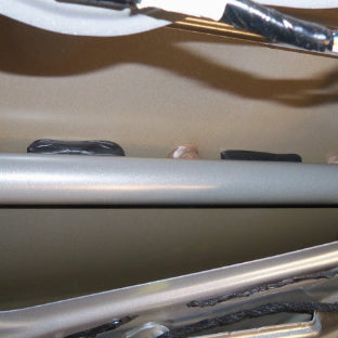 Butyl tape used to decouple crash bar from door skin