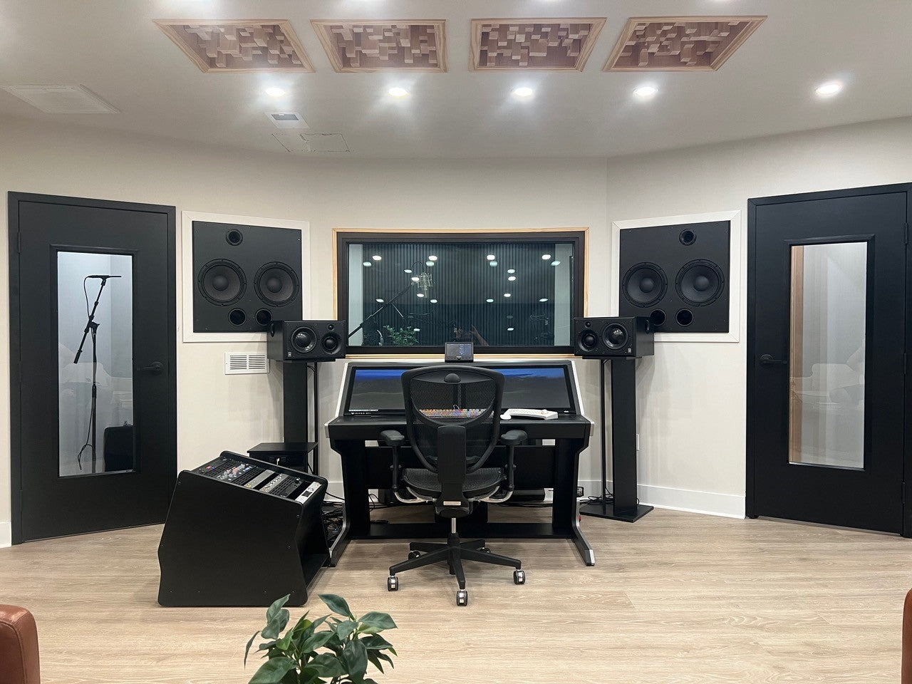 Recording studio control room with Tru Acoustics soundproof window, Sound Lock doors, and ceiling diffuser panels