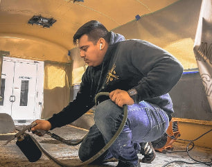 Spraying Spectrum liquid soundproofing in the Mini Bus
