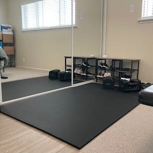 stomp mat rubber flooring used in the corner of a room for a small home gym