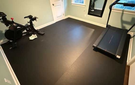 stomp roll rubber flooring with a treadmill and a exercise bike