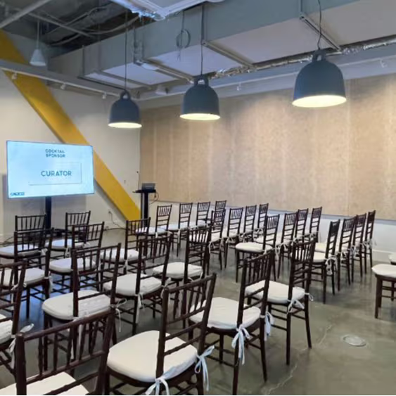 Event venue with rows of chairs set up for a seminar or conference presentation