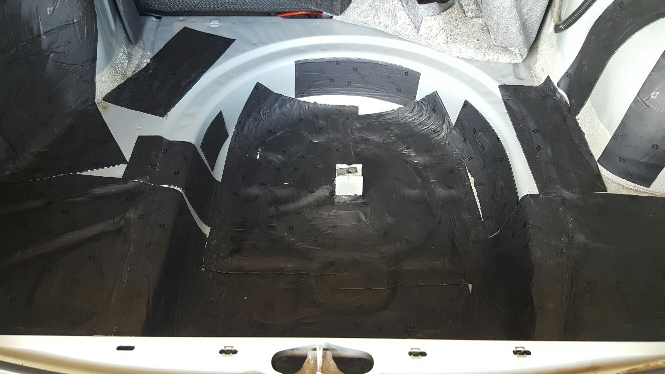 Damplifier Pro sound deadening mat installed throughout Chevy Cavalier trunk floor and wheel wells