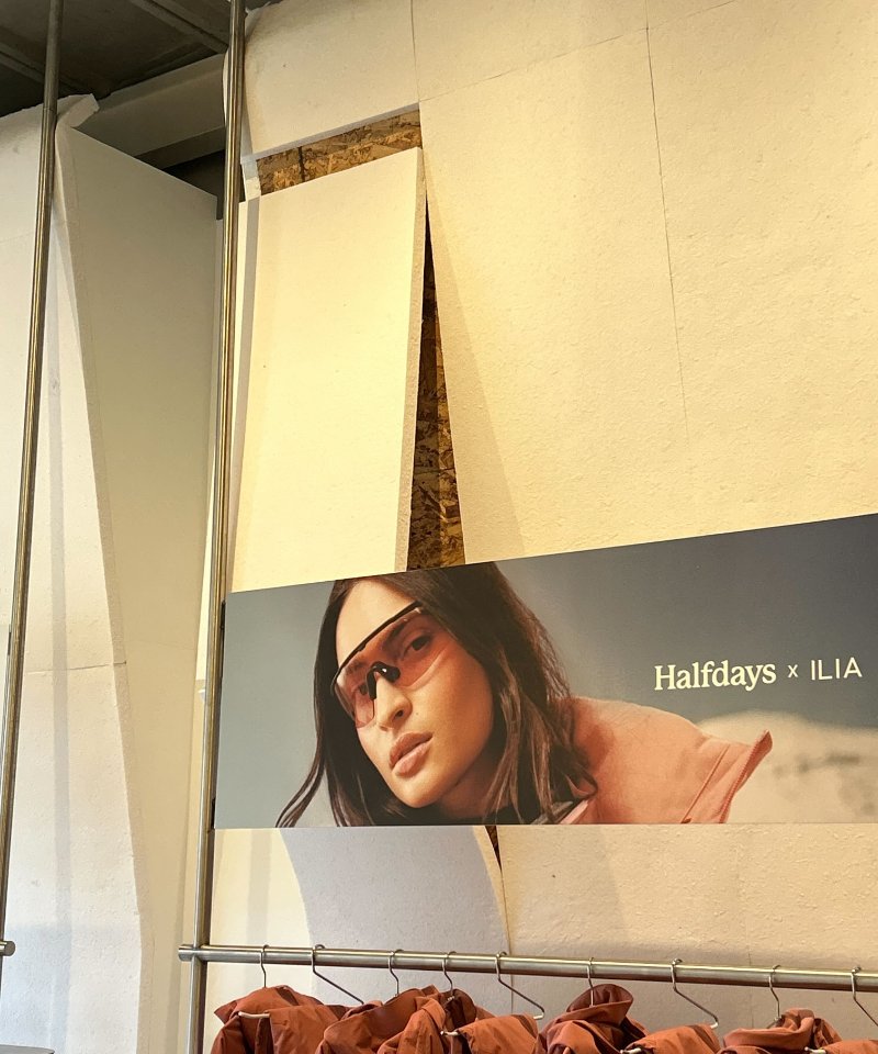 White EcoVerb panels applied to a wall behind a clothing rack