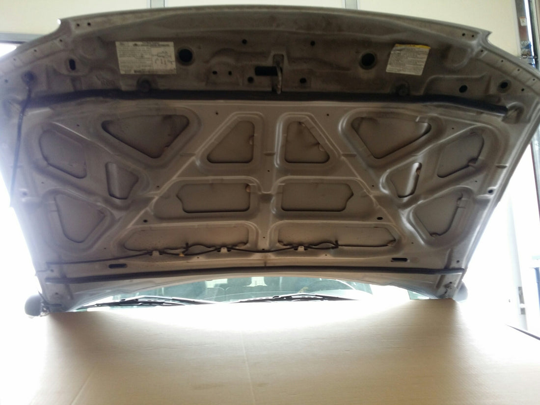 Car hood open showing bare inner panel before Damplifier Pro sound deadening installation