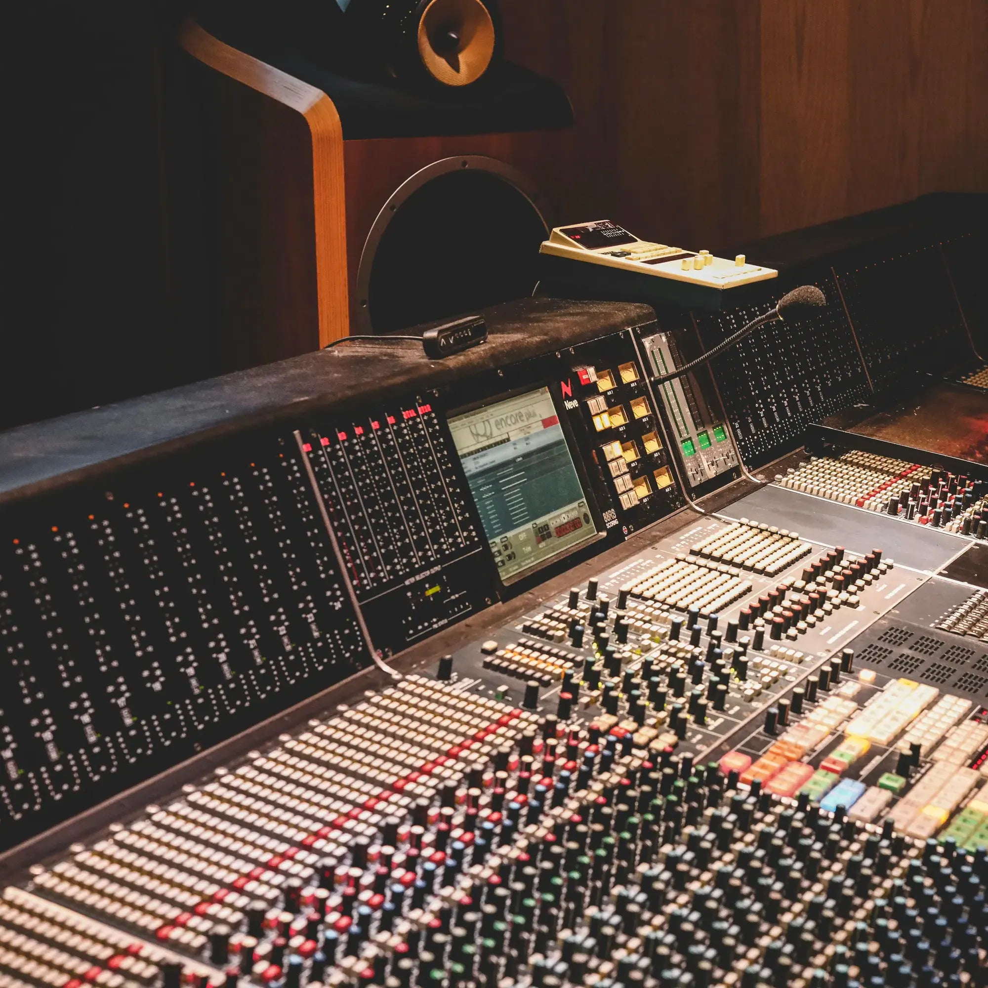 Large audio mixing console in a recording studio setting