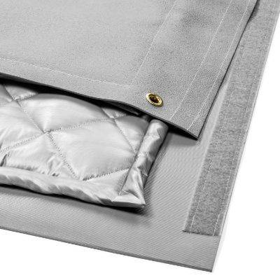 Quiet Quilt sound blanket with quilted silver interior lining, grey exterior, and brass grommet