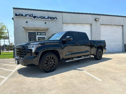 Black Toyota Tundra truck parked outside Sound Evolution shop, showcasing vehicle audio/soundproofing installation