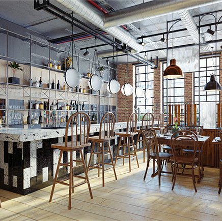 Industrial-style restaurant interior with exposed brick and open ceiling, illustrating commercial acoustic treatment needs