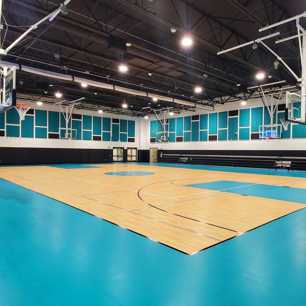 Light blue and dark grey Timberwool acoustic panels on the walls in a gym