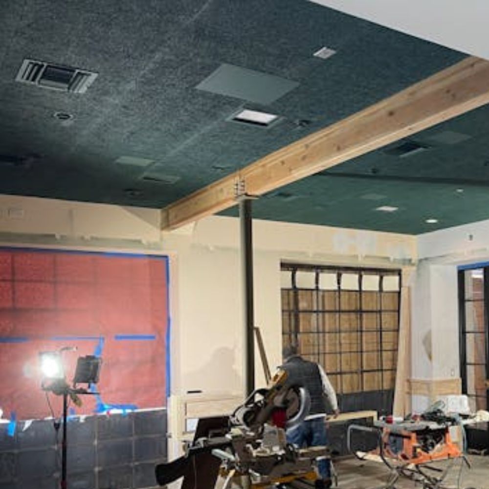 Timberwool wood fiber acoustic panels painted green and installed on ceiling